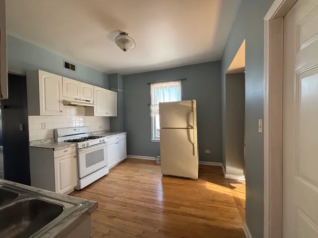 a kitchen with a refrigerator sink and stove