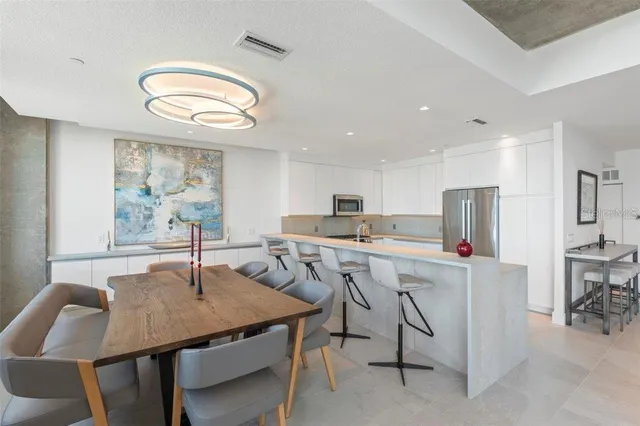 a kitchen with granite countertop a sink stainless steel appliances and cabinets