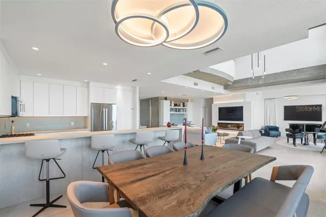 a living room with furniture a flat screen tv and a window