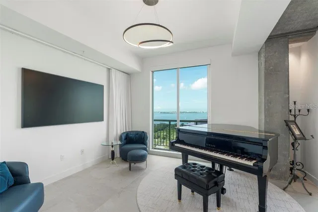 a living room with a bed furniture and a large window