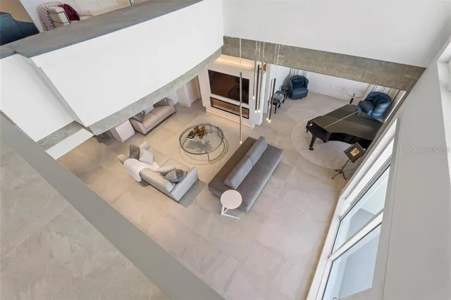 a living room with furniture and a floor to ceiling window