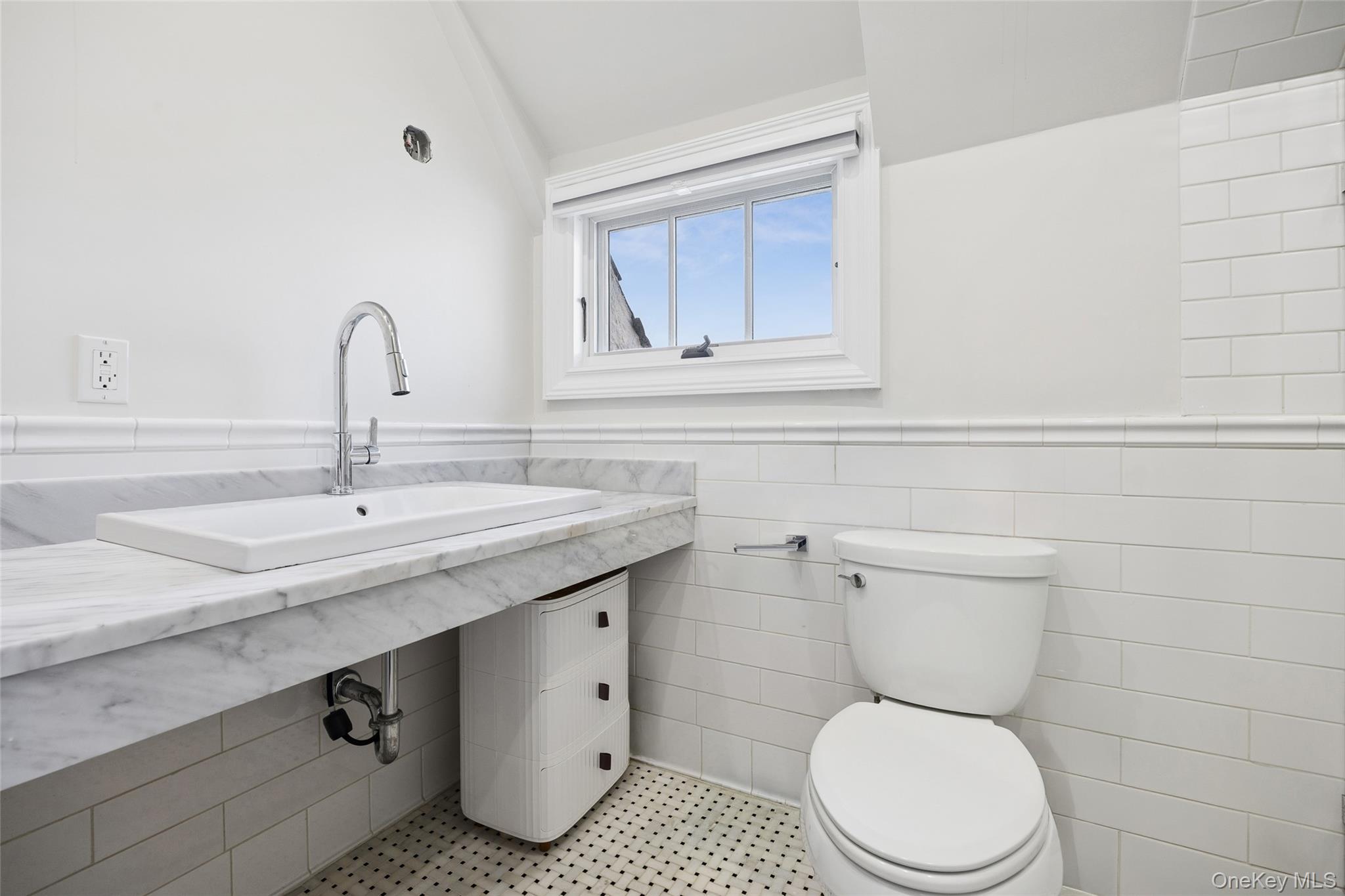 216 Beverly Road Queens, NY 11363 - Photo 15 of 50 a bathroom with a toilet a sink and mirror