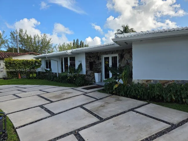 a front view of a house with garden