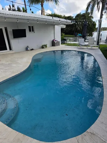 a view of a swimming pool with an outdoor seating