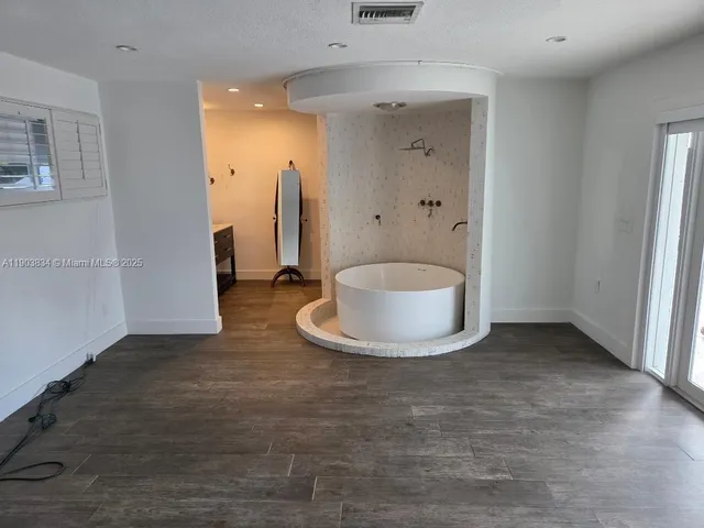 a view of a bathroom with a sink and a mirror
