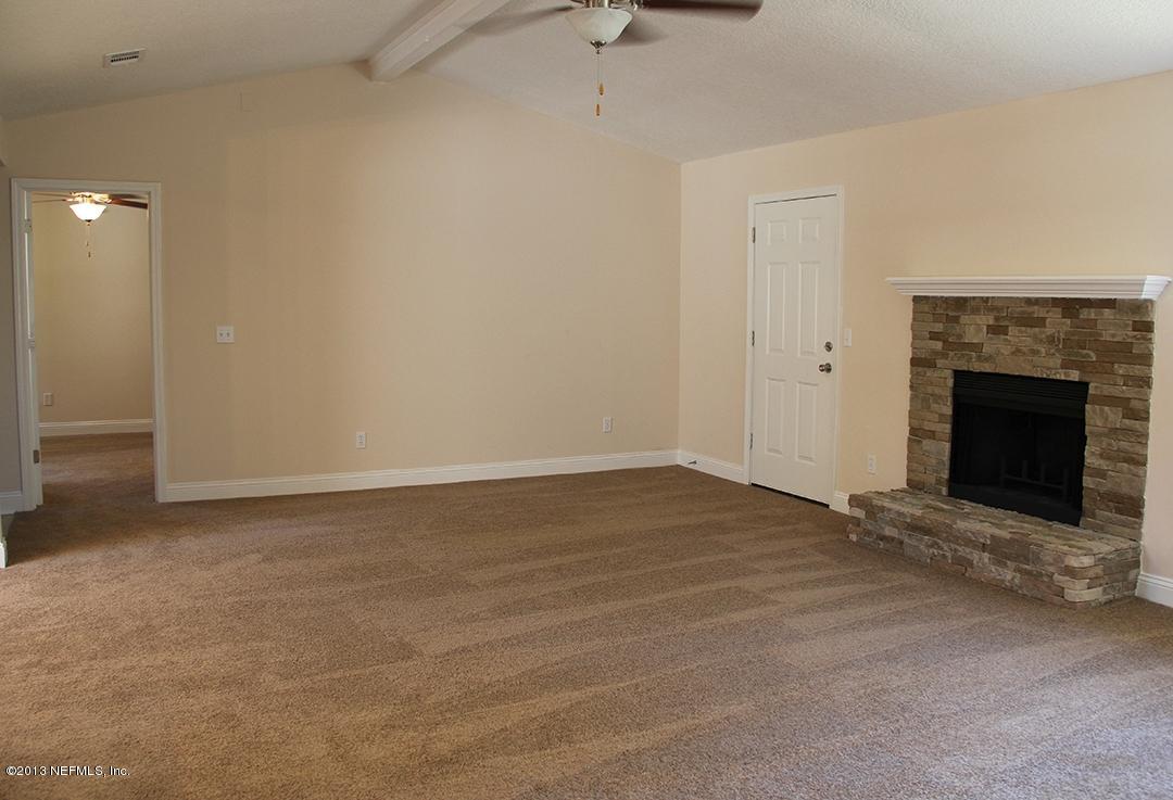 2128 Blair Road Jacksonville, FL 32221 - Photo 8 of 11 a view of an empty room with wooden floor and a fireplace