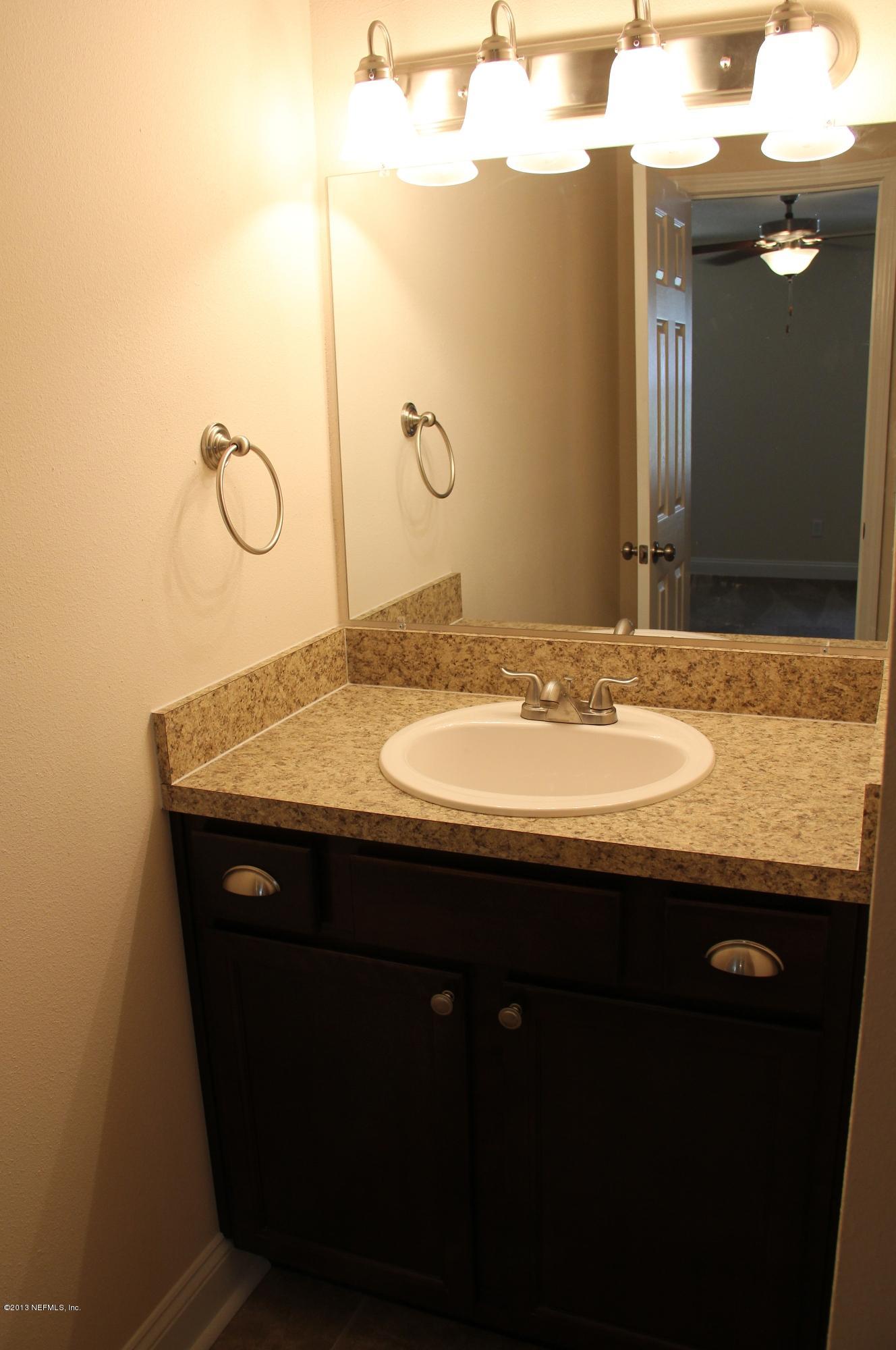 2128 Blair Road Jacksonville, FL 32221 - Photo 10 of 11 a bathroom with a granite countertop sink a mirror and a