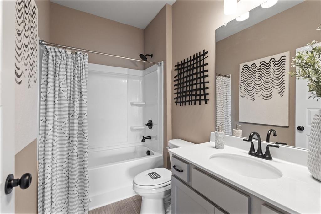 235 Bastian Drive, Unit 17 Villa Rica, GA 30180 - Photo 18 of 30 a bathroom with a sink toilet vanity and shower