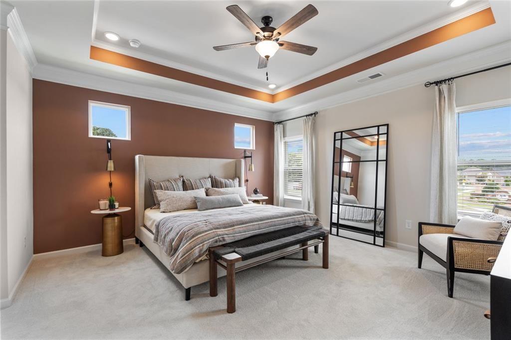 235 Bastian Drive, Unit 17 Villa Rica, GA 30180 - Photo 29 of 30 a bedroom with a bed and a chandelier