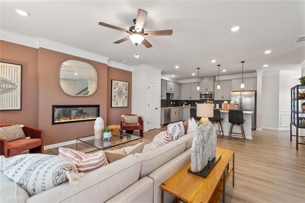 235 Bastian Drive, Unit 17 Villa Rica, GA 30180 - Photo 7 of 30 a living room with furniture kitchen view and a chandelier