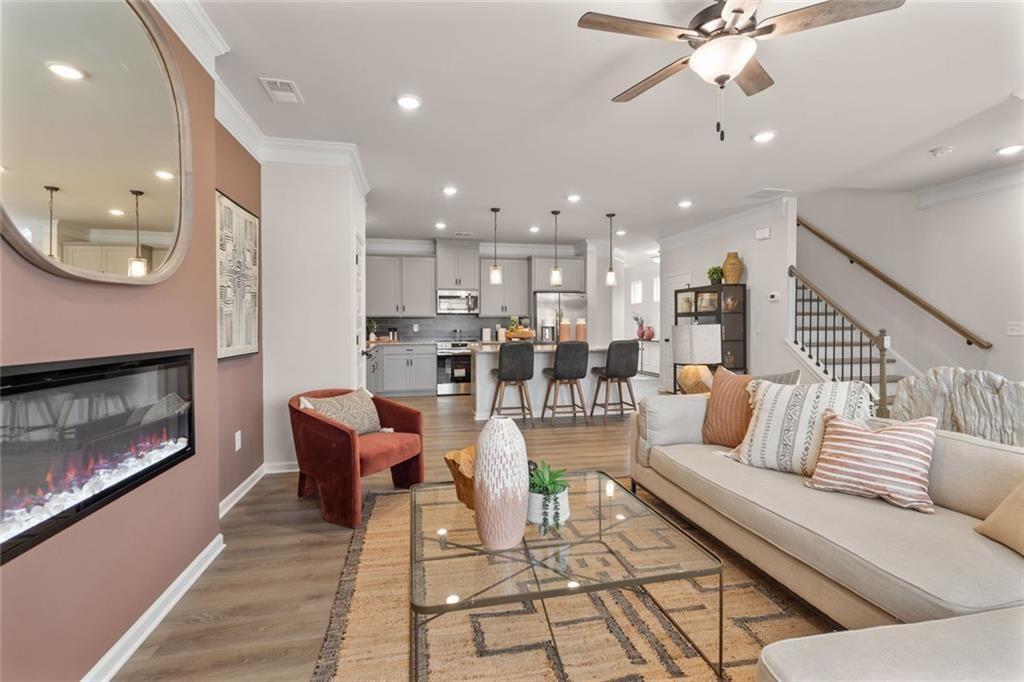 235 Bastian Drive, Unit 17 Villa Rica, GA 30180 - Photo 8 of 30 a living room with furniture kitchen view and a fireplace