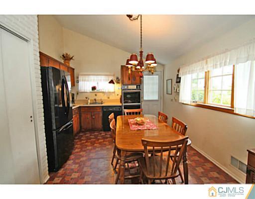 78 Westminster Road Colonia, NJ 07067 - Photo 3 of 25 a view of a dining room and chandelier
