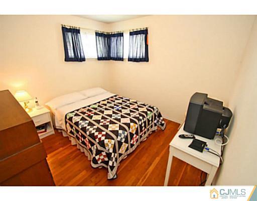 78 Westminster Road Colonia, NJ 07067 - Photo 22 of 25 a bedroom with a bed and couch