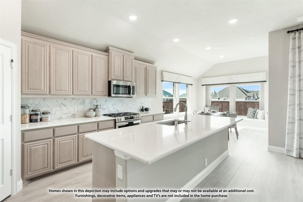 1152 Hitching Post Way Oak Point, TX 75068 - Photo 20 of 36 a large white kitchen with granite countertop a stove a sink a refrigerator and white cabinets with wooden floor