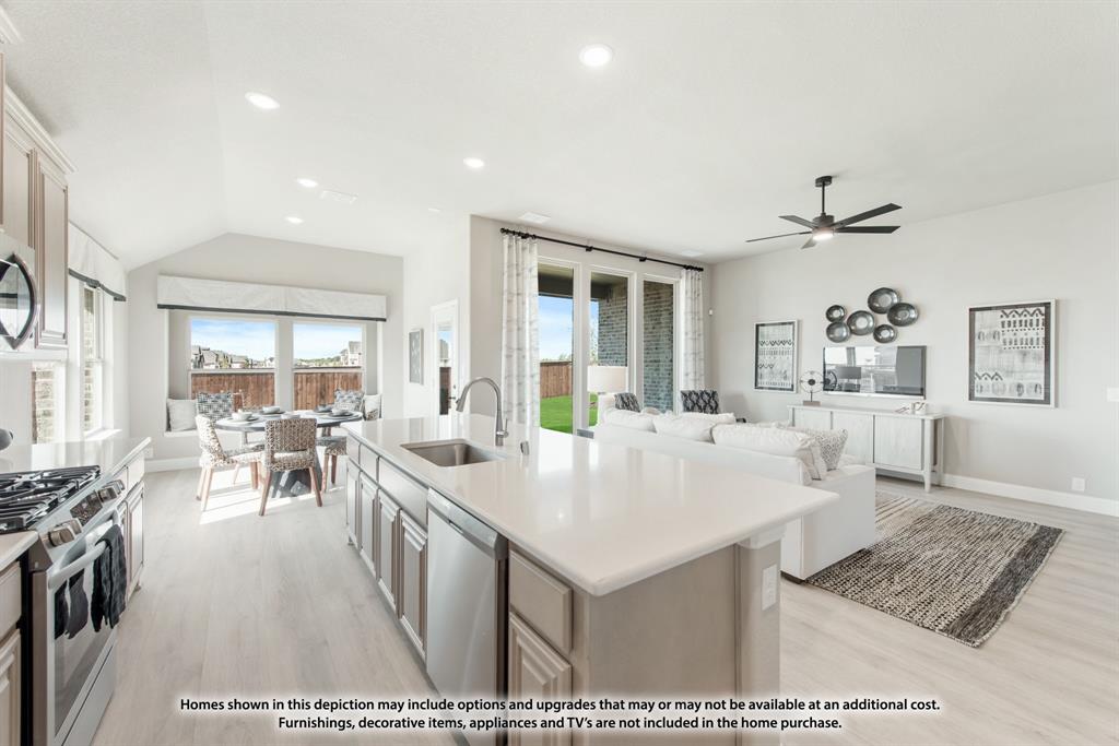 1152 Hitching Post Way Oak Point, TX 75068 - Photo 21 of 36 a very nice looking dining room with kitchen island a stove a table and chairs