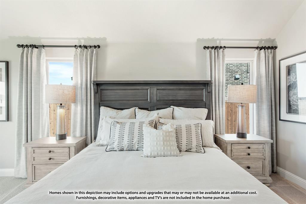 1152 Hitching Post Way Oak Point, TX 75068 - Photo 30 of 36 a bedroom with a large bed and a chandelier