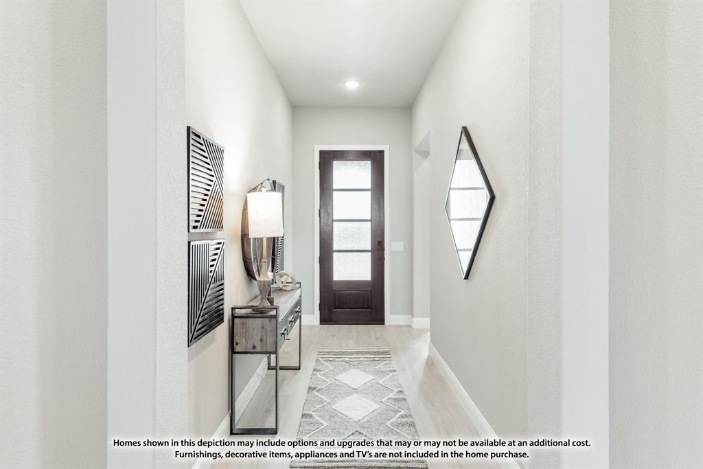 1152 Hitching Post Way Oak Point, TX 75068 - Photo 3 of 36 a view of a hallway with wooden floor and furniture