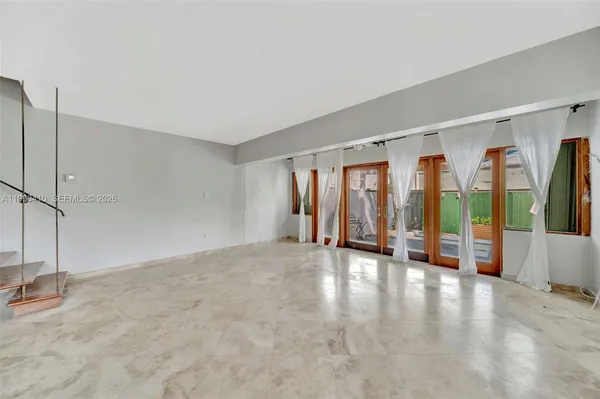 a spacious bathroom with a granite countertop sink a toilet a mirror and bathtub