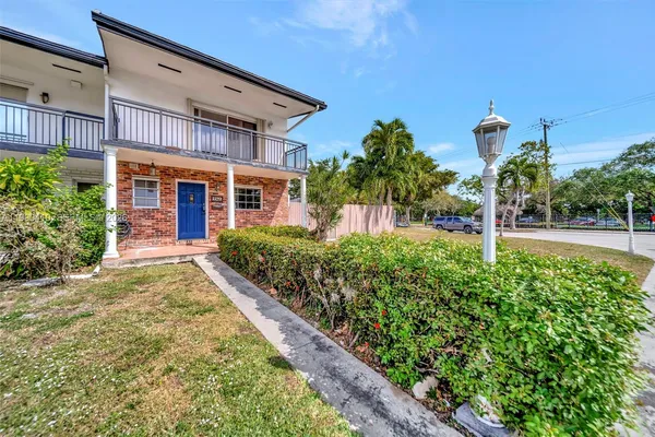 a kitchen with stainless steel appliances granite countertop a stove top oven a sink dishwasher a dining table and chairs with wooden floor