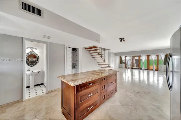 a kitchen with stainless steel appliances granite countertop a stove a sink and a refrigerator