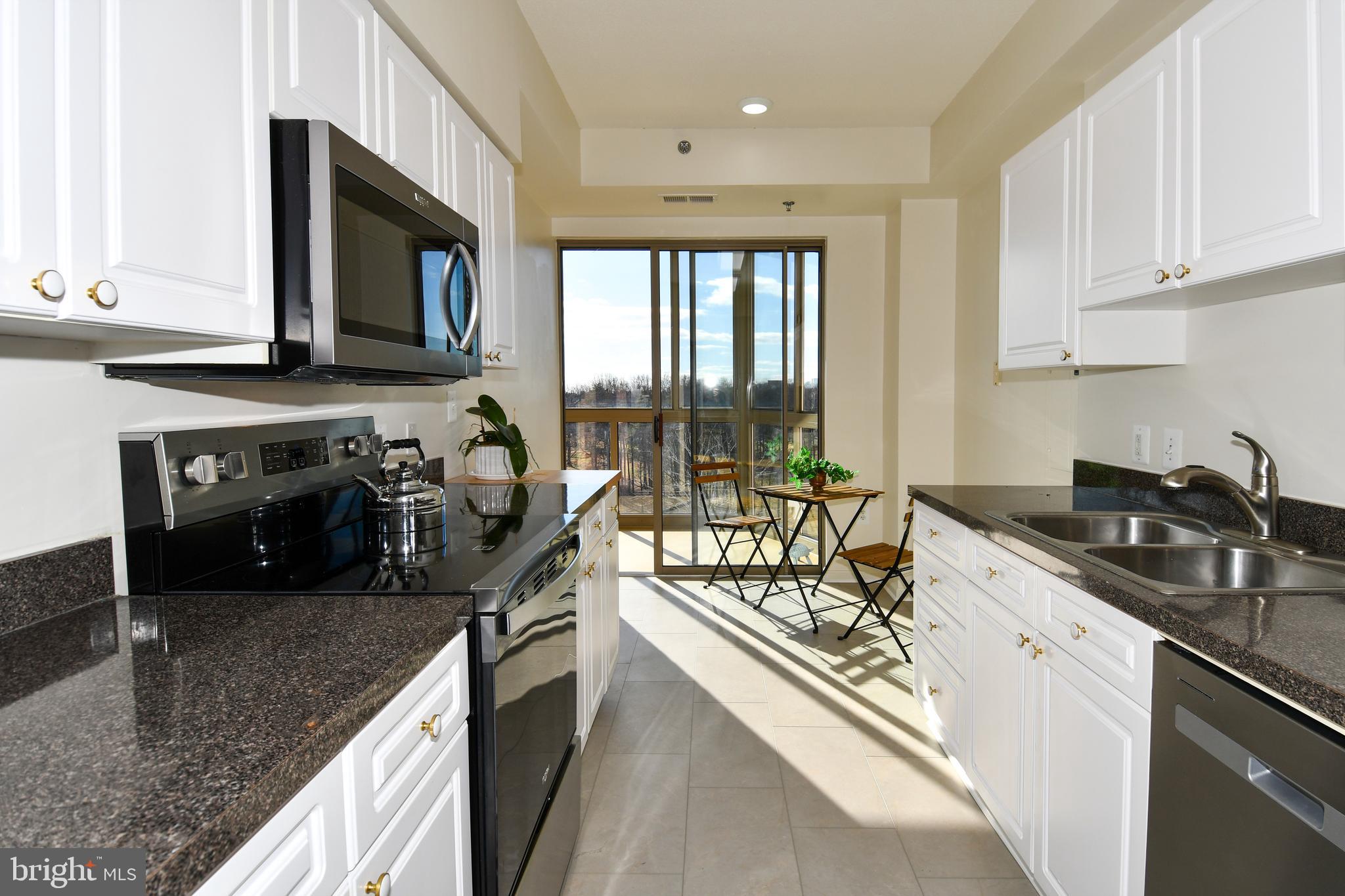 3100 North Leisure World Boulevard, Unit 801 Silver Spring, MD 20906 - Photo 25 of 69 a kitchen with a sink stove and cabinets