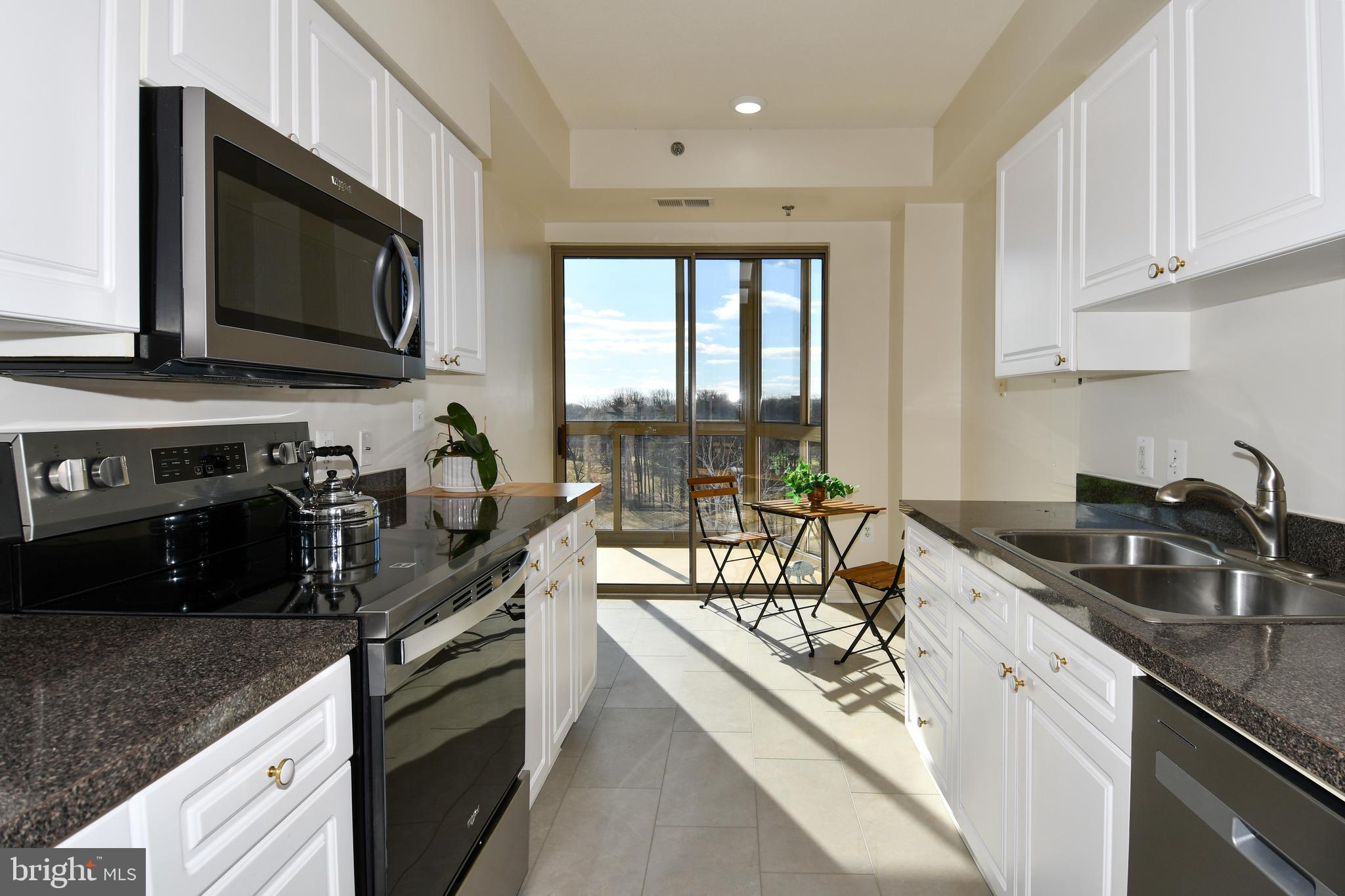 3100 North Leisure World Boulevard, Unit 801 Silver Spring, MD 20906 - Photo 27 of 69 a kitchen with stainless steel appliances granite countertop a sink stove and microwave