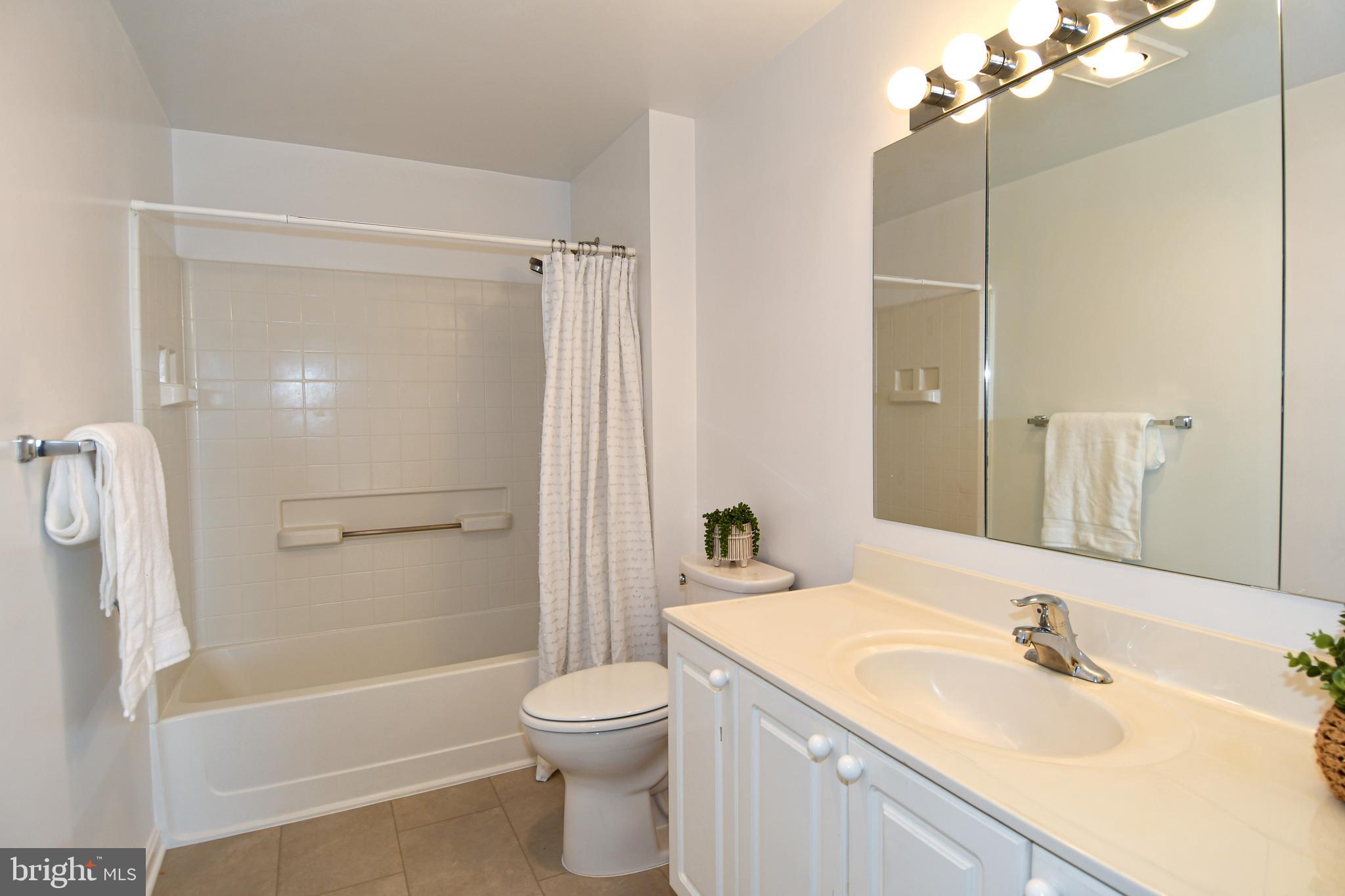 3100 North Leisure World Boulevard, Unit 801 Silver Spring, MD 20906 - Photo 47 of 69 a bathroom with a granite countertop sink toilet and shower
