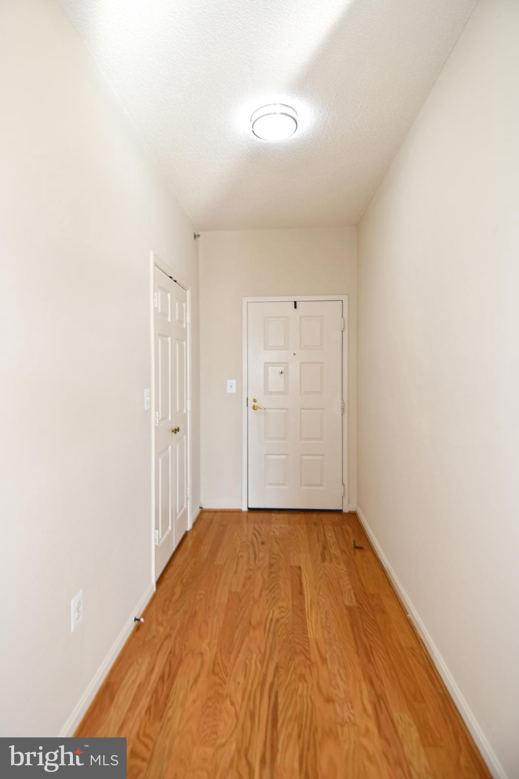 3100 North Leisure World Boulevard, Unit 801 Silver Spring, MD 20906 - Photo 5 of 69 a view of a room with a wooden floor and white walls