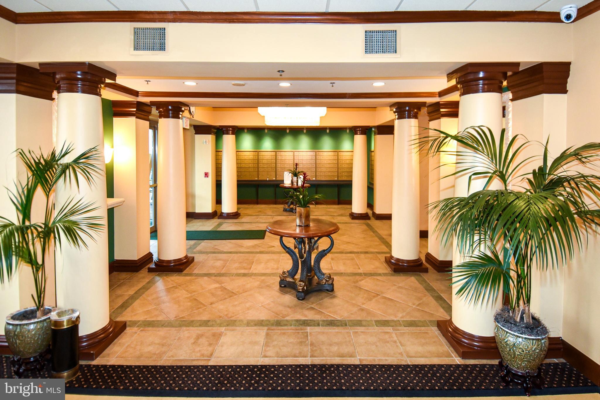 3100 North Leisure World Boulevard, Unit 801 Silver Spring, MD 20906 - Photo 56 of 69 a view of a swimming pool with potted plants and palm trees