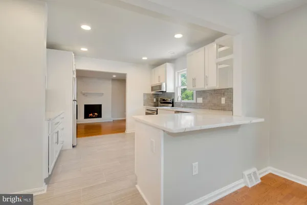 a kitchen with stainless steel appliances granite countertop a sink and cabinets