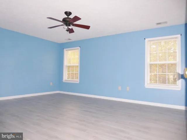 a view of room with a ceiling fan and window
