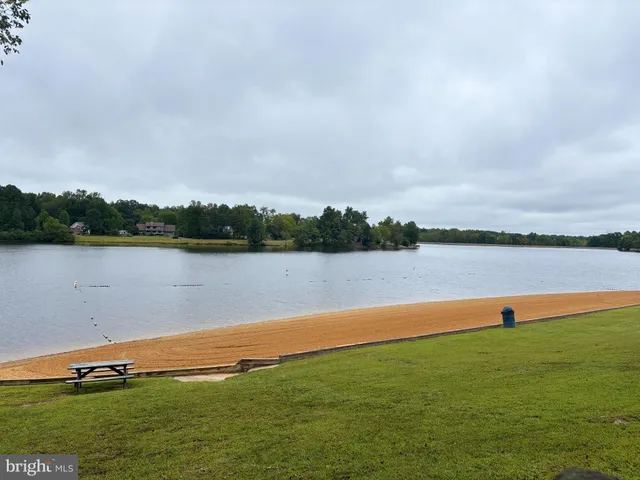 a view of a lake with houses in the back