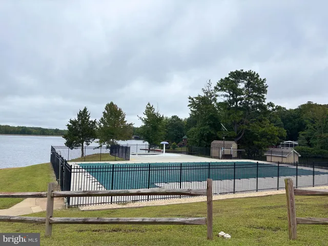 a view of a swimming pool with a yard