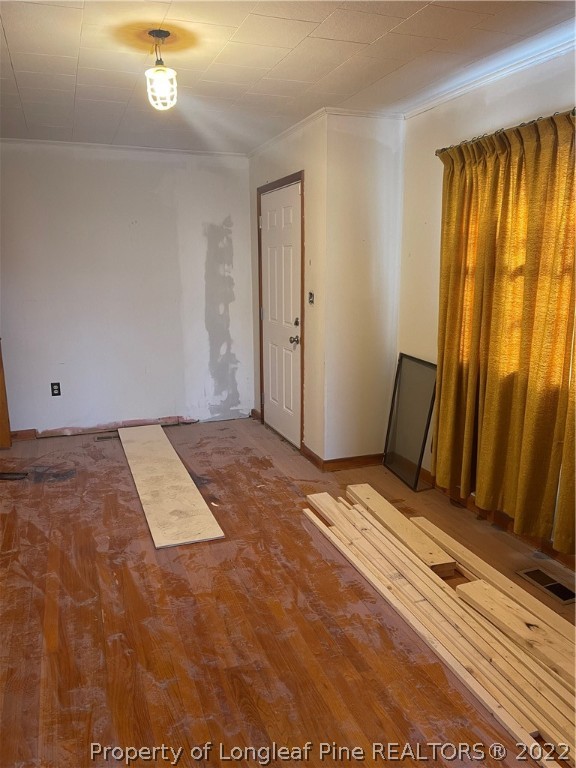 6990 Rockfish Road Fayetteville, NC 28306 - Photo 3 of 12 a view of a room with wooden floor and windows