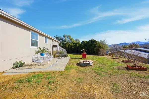 a backyard of a house with table and chairs