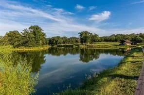 a view of a lake with houses in the back