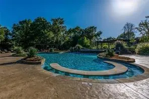 a view of a swimming pool with a yard
