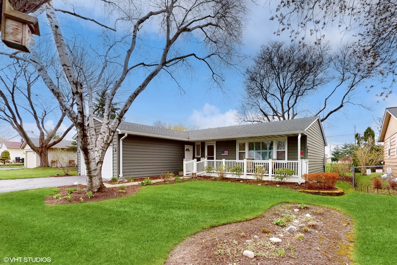 a view of a house with backyard and a tree