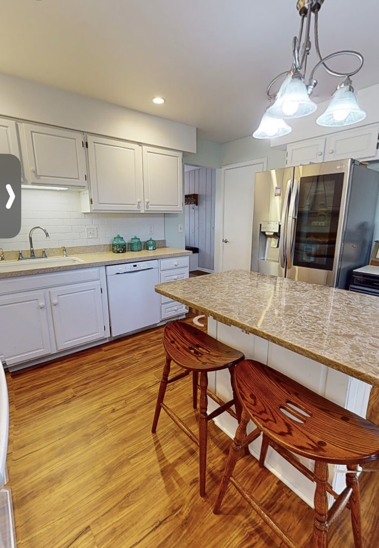 48 Lloyd Street Cary, IL 60013 - Photo 12 of 62 a kitchen with stainless steel appliances granite countertop a sink and cabinets
