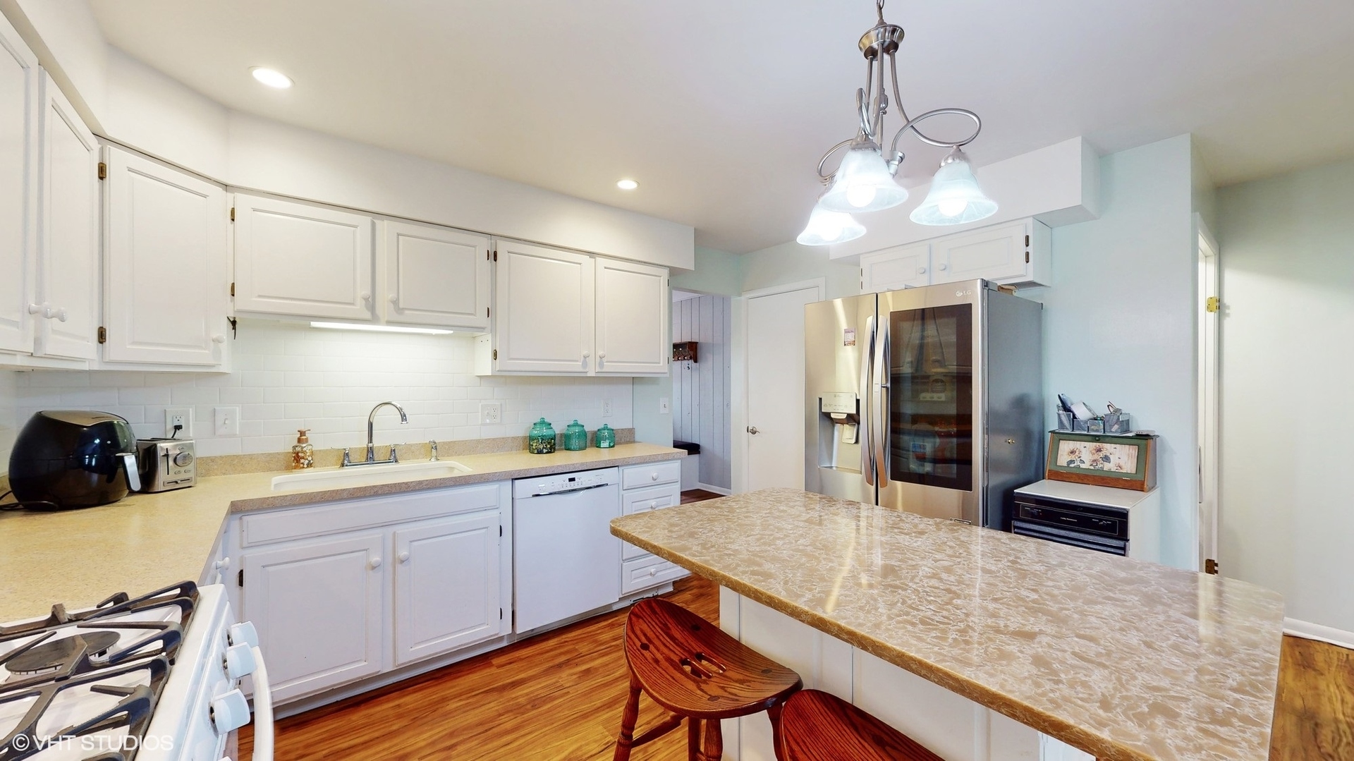 48 Lloyd Street Cary, IL 60013 - Photo 15 of 62 a kitchen with kitchen island granite countertop a sink a center island and cabinets