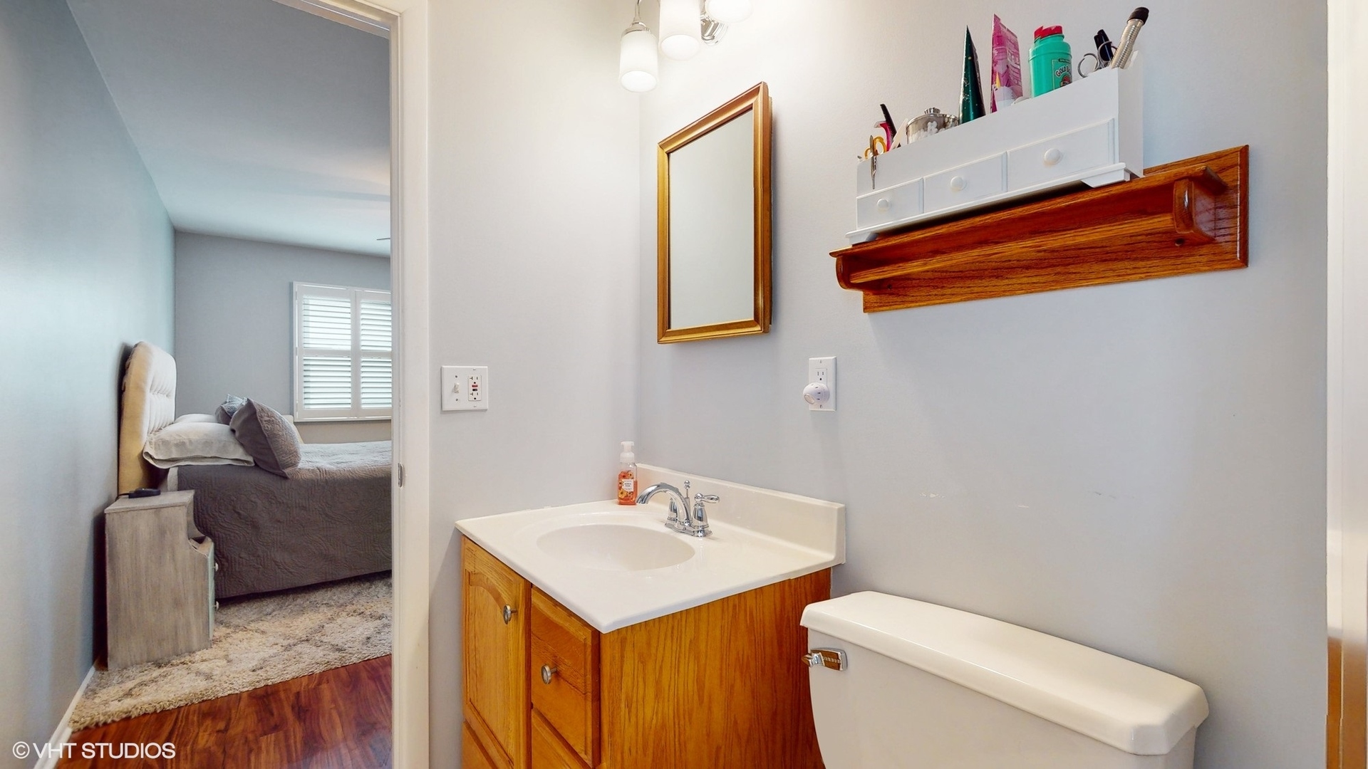 48 Lloyd Street Cary, IL 60013 - Photo 28 of 62 a en suite bathroom with a toilet sink and mirror