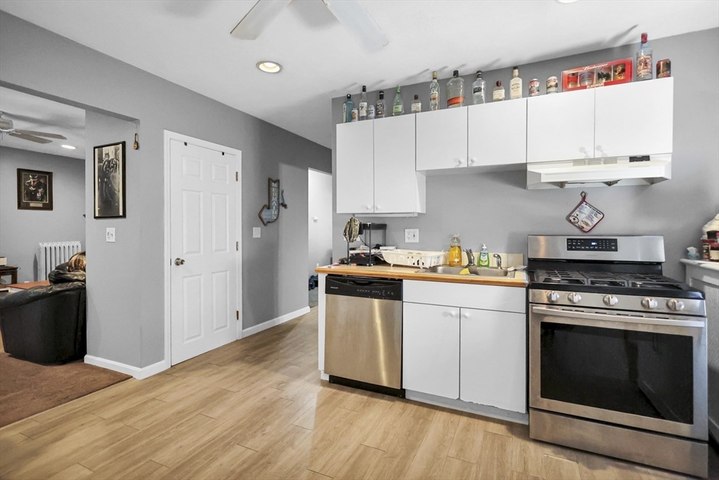 26 Gage Street Methuen, MA 01844 - Photo 13 of 29 a kitchen with stainless steel appliances a white stove top oven and cabinets