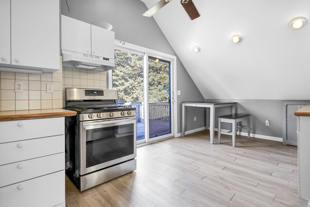 26 Gage Street Methuen, MA 01844 - Photo 22 of 29 a kitchen with granite countertop a stove and a wooden floors
