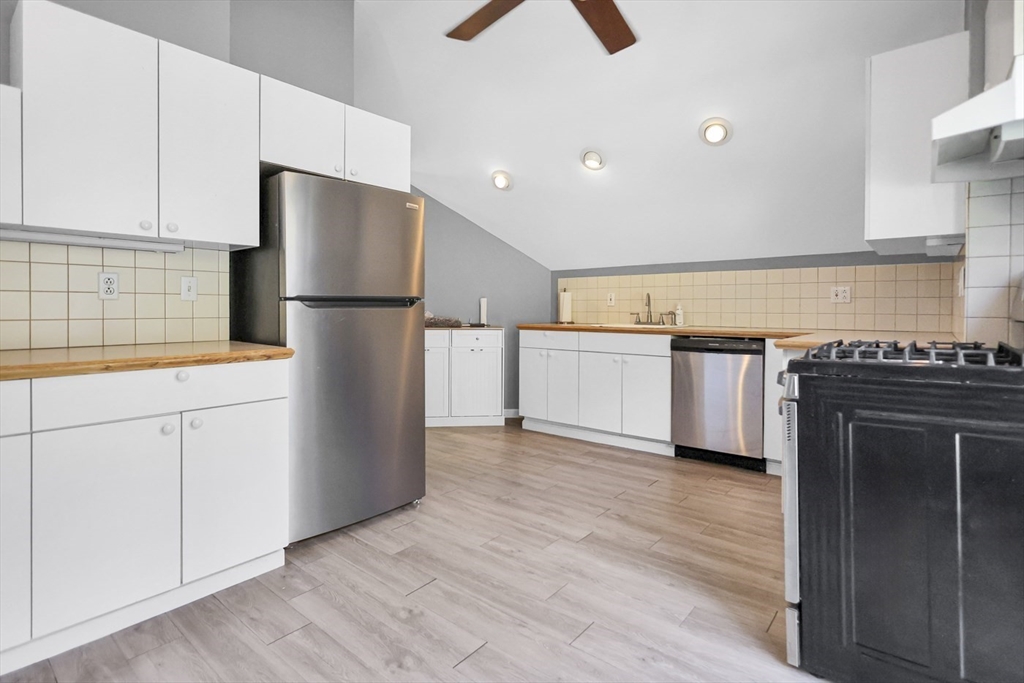 26 Gage Street Methuen, MA 01844 - Photo 23 of 29 a kitchen with granite countertop a refrigerator and a stove top oven