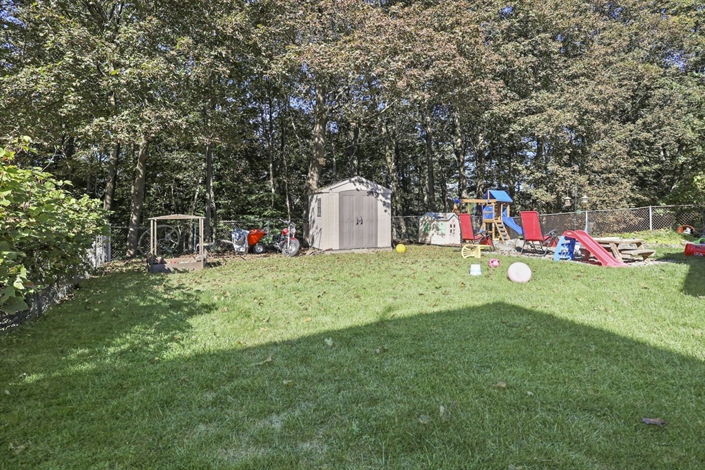 26 Gage Street Methuen, MA 01844 - Photo 27 of 29 a view of a white house with a small yard and large trees