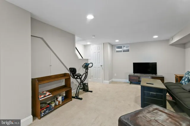 a view of a room with gym equipment and a flat screen tv