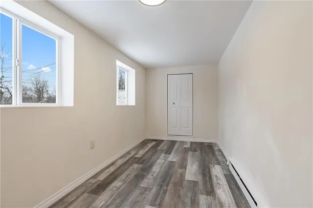 a view of room with window and hardwood floor