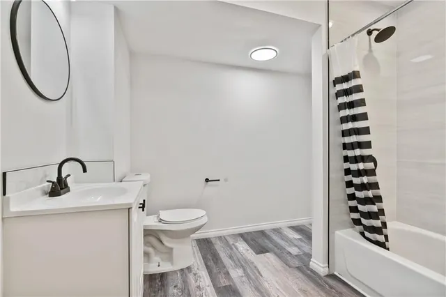 a bathroom with a sink a toilet and a shower