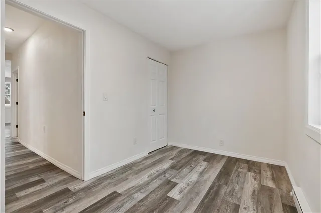 a view of a room with wooden floor