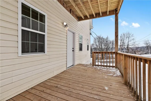 a view of a balcony with wooden floor and fence